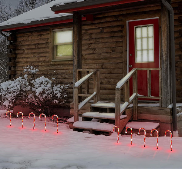 Candy Cane Outdoor Landscape Lights show in front of cabin